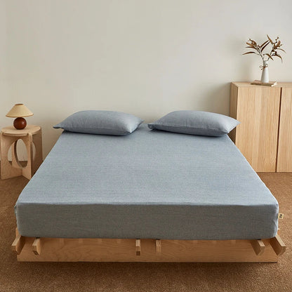 Drap housse 180x200 bleu sur un lit